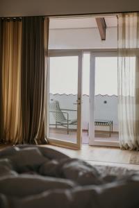 a bedroom with a bed and a view of the ocean at Langhoff & Juul Boutique Hotel og Restaurant in Ebeltoft