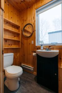 a bathroom with a toilet and a sink and a window at Le 2800 du Parc in Shawinigan +143 photos