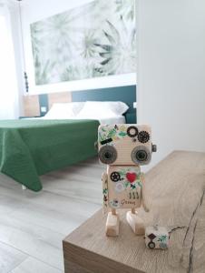 a toy robot sitting on a table in a bedroom at Corso Matteotti 162 - Affittacamere in Porto Recanati