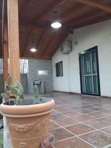 a large pot sitting on a patio with a cactus at Casa del Sol in Santa María