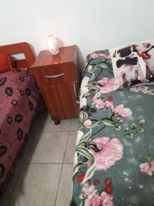 a dog laying on a bed next to a night stand at Casa del Sol in Santa María