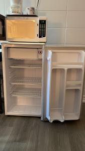 an open refrigerator and microwave in a kitchen at Bel-Air Motel in Sault Ste. Marie