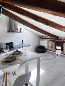 a kitchen with a table and chairs and a fireplace at Apartamentos Numancia in Garray