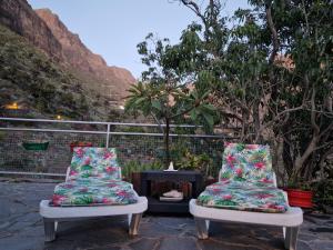 two chairs sitting on a patio with a table at Casa Berna in Masca
