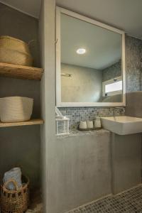 a bathroom with a sink and a mirror at Mourelo Home in Gavalochori