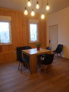 a dining room with a wooden table and chairs at Le Laurenti in Quérigut