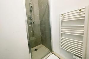 a shower with a glass door in a bathroom at #Y7 La Résidence Studio Caserne de Bonne Private residence in Grenoble