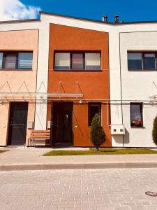 a building with a bench in front of it at Comfortable Townhouse in Vilnius