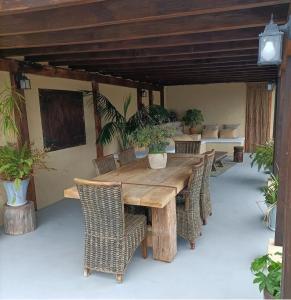 a wooden table and chairs on a patio at Villamasai "Un pedacito de África en Valencia" in Valencia