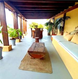 a living room with a table on a balcony at Villamasai "Un pedacito de África en Valencia" in Valencia +14 photos