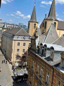 an old building with two towers on a city street at Luxurious 1 bedroom in the Heart of City Center - 25 in Luxembourg