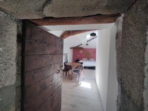 a room with a table and a room with a bedroom at Yac'Aventures in Dargoire