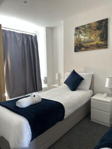 a bedroom with a large bed and a window at Courtyard Stay in Norwich
