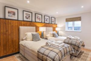 a bedroom with two beds with towels on them at Stratheck Holiday Park in Dunoon