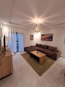 a living room with a couch and a coffee table at COSTA MAR MARTIL 2 TETOUAN in Martil