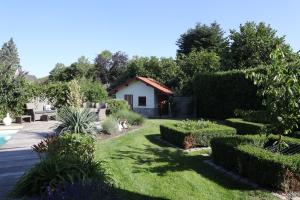 a garden with a pool and a house at Au Temps de Spa - La Tour du Tonnelet in Spa