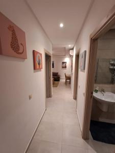 a hallway of a bathroom with a sink and a tub at COSTA MAR MARTIL 2 TETOUAN in Martil