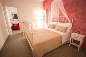 a bedroom with a large bed with a canopy at Venustas in Lampedusa