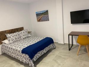Ein Bett oder Betten in einem Zimmer der Unterkunft Suites Benalup Centro