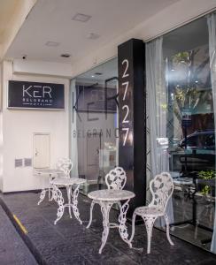 a group of tables and chairs in front of a store at Ker Belgrano Hotel in Buenos Aires