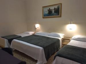 Postel nebo postele na pokoji v ubytování Pensione Trento
