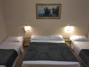 Postel nebo postele na pokoji v ubytování Pensione Trento