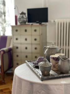 a table with a tray with tea pots on it at Le Chalet d'Ouchy in Lausanne