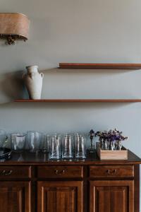 a wooden table with glasses on top of it at Villa Nottola in Montepulciano