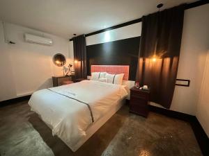 a bedroom with a large white bed and a window at CJ HOUSE station 18 Ipoh in Ipoh
