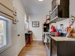 a kitchen with a stove top oven next to a window at Mountain Bungalow-Walk to Downtown/Biker's Dream! in Hot Springs