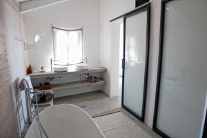 a bathroom with a glass shower and a sink at Sisters-Homes Vidovići 9 in Martinšćica