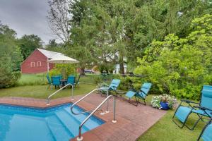 a swimming pool with chairs and an umbrella at All Year-Round Retreat Near Windham Mountain 