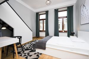 a white bedroom with a bed and a desk at Beautiful apartment, great location, Old Town & Kazimierz in Kraków