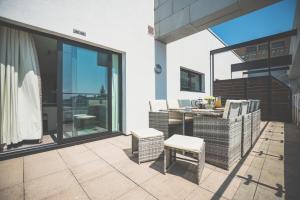 a patio with a table and chairs on a balcony at NOVU Apartments Liverpool Waterfront in Liverpool