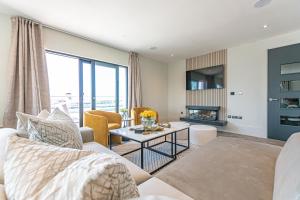 a living room with a couch and a table at NOVU Apartments Liverpool Waterfront in Liverpool