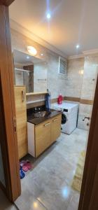 a small kitchen with a sink and a stove at Baris Mah, Kardelen Sk. BekTek Sit, N.12 B1 K.12 D.24 Beylikduzu/istanbul 34520 Turkey in Beylikduzu