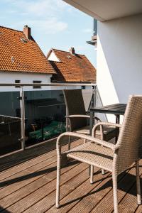 a patio with two chairs and a table on a balcony at Dill Apartments Stederdorf in Peine