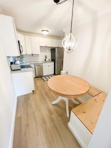 a kitchen with a wooden table in a room at Retreat at Fenwick in Leonardtown