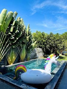 a pool with a unicorn float in a swimming pool at Villa có hồ bơi riêng tại Lang Phuoc Hai 