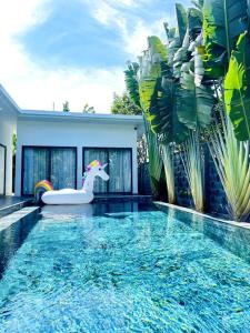 a swimming pool with a unicorn bathtub in a house at Villa có hồ bơi riêng tại Lang Phuoc Hai 