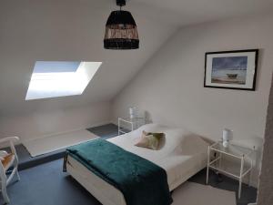 ein kleines Schlafzimmer mit einem Bett und einem Fenster in der Unterkunft Duplex Le Reflet du Lac in Malbuisson