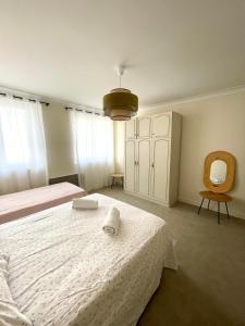 a bedroom with a bed with a towel on it at Maison Colonel Teyssier in Albi