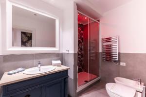 a bathroom with a sink and a shower and a toilet at Trastevere Paper Suites in Rome