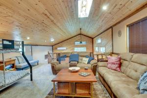 a living room with a couch and a table at Lakefront Outing Home Private Dock and Volleyball! in Emily