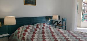a bedroom with a bed with a quilt on it at Port FREJUS OPEN 2 pieces 40m2 in Fréjus +14 photos