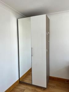 two glass doors in an empty room with wood floors at Large whole house with 7 bedrooms in S.Norwood in Norwood