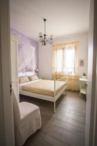 a bedroom with a bed and a chandelier at Venustas in Lampedusa