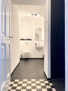 a bathroom with a black and white checkered floor at zehuus - historical charm 70qm in Cologne +21 photos