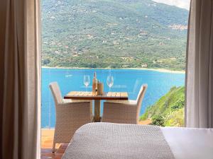 a table and chairs with a view of the ocean at Miramar Corsica in Propriano