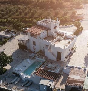 an aerial view of a white house with a swimming pool at Masseria Sant'Elia Castellaneta in Castellaneta